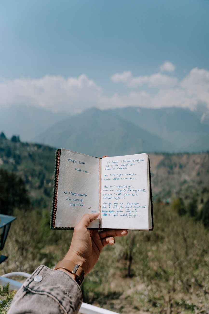Travel writer with journal in alpine retreat